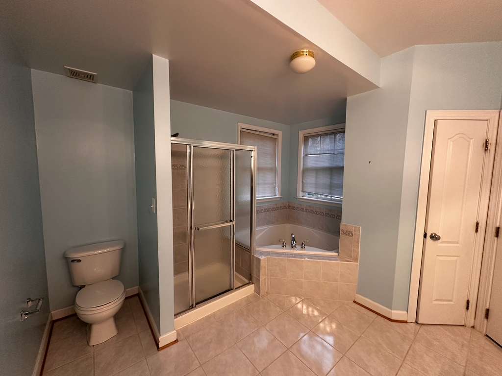 Before: Dated corner tub to a marble wet-room