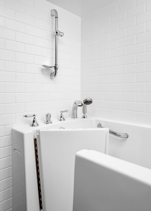 White walk-in tub with shiny silver faucets and safety handles